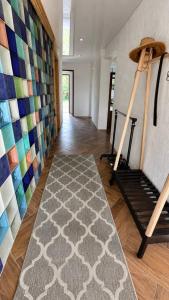 a hallway with a rug and a wall with colorful tiles at Suur ja Hubane maja, Saaremaal in Saareküla