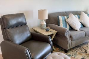 a leather chair in a living room with a couch at Bay Creek Villa - 304 in Edisto Island
