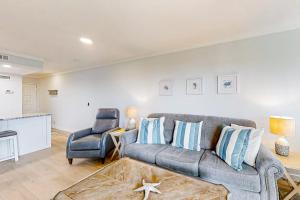 a living room with a couch and a chair at Bay Creek Villa - 304 in Edisto Island