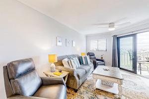 a living room with a couch and a table at Bay Creek Villa - 304 in Edisto Island +15 photos