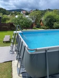 a swimming pool with a slide next to it at Bliss Cottage in Slavske