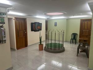 a lobby with a plant in the middle of a room at Hotel Don Fermin in Barranquilla