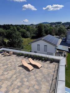 an aerial view of a patio with two lounge chairs at Exclusive Apartment mit Alpenpanorama in Peiting