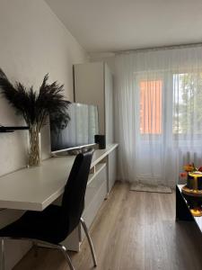 a office with a desk and a chair and a window at Apartment Ventspils iela 22 in Rēzekne