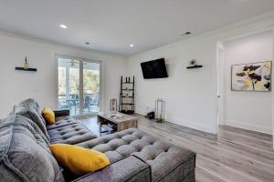 a living room with a couch and a television at Nature's Touch in Edisto Island