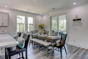 a dining room with a table and chairs at Nature's Touch in Edisto Island +32 photos