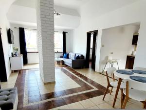a living room with a couch and a table at Apartament Nad Lodziarnią in Wydminy