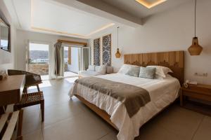 a bedroom with a large bed and a desk at Thalassa boutique hotel-Adults only in Platis Gialos +55 photos