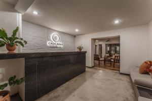 a lobby with a bar and a dining room at Casa Aura Hotel, Mérida in Mérida