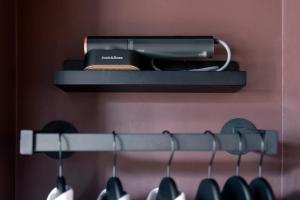 a hair dryer on a shelf in a closet at Flatiron Studio Near Madison Square Park in New York +36 photos
