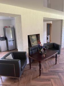 a living room with two couches and a coffee table at Suur ja Hubane maja, Saaremaal in Saareküla