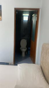 a small bathroom with a toilet in a room at First American Inn in Borsh +8 photos