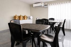 a dining room with a table and chairs at Hotel Vilasa Grand in Guwahati +10 photos