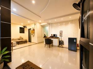 a person sitting at a desk in a living room at Suardana Inn's in Kuta