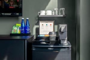 a hotel room with a coffee maker and bottles on a counter at NoMad Studio Near Broadway & Madison Square in New York