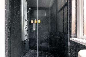 a shower with a glass door in a bathroom at NoMad Studio Near Broadway & Madison Square in New York