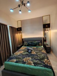 a bedroom with a bed with a stuffed animal on it at inspiria condo davao 14th in Davao City