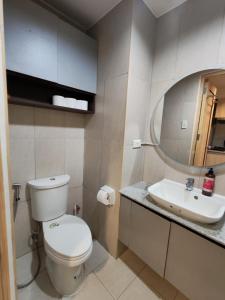 a bathroom with a toilet and a sink and a mirror at inspiria condo davao 14th in Davao City +10 photos