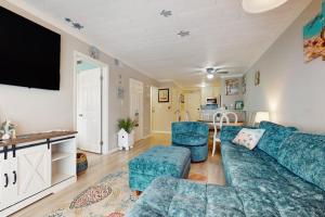 a living room with a blue couch and chairs at Fiddlers Cove 6J in Hilton Head Island