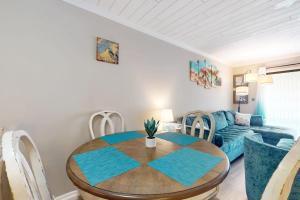 a living room with a table and a couch at Fiddlers Cove 6J in Hilton Head Island