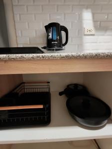 a coffee pot and a skillet on a shelf at inspiria condo davao 14th in Davao City