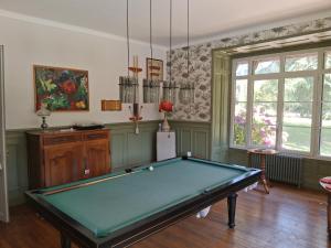 a pool table in a living room with at Caux Loc' du Manoir in Graincourt