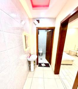 a bathroom with a toilet and a sink at شاليهات زارا 2 in Taif