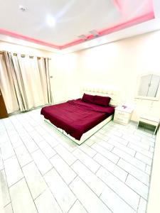 a bedroom with a bed and a white tiled floor at شاليهات زارا 2 in Taif