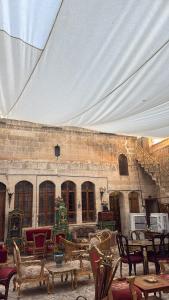 a room with chairs and tables and a tent at antik senyora butik in Urfa