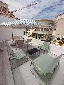 a group of chairs and umbrellas on a patio at Maria's in Faro