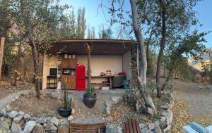 a small house with a red refrigerator in a yard at Glamping Ramas De Elqui in Pisco Elqui +17 photos