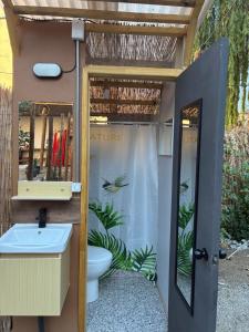 a bathroom with a sink and a toilet at Glamping Ramas De Elqui in Pisco Elqui