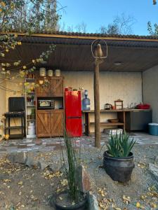 a kitchen with a red refrigerator in a backyard at Glamping Ramas De Elqui in Pisco Elqui