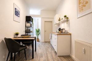 a kitchen and dining room with a table and a refrigerator at Beesenkammer - zentrales StudioApartment Halle in Halle an der Saale