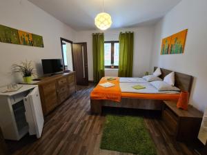 a bedroom with a bed with an orange blanket at Vila Laura 1 in Sovata