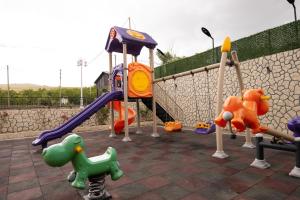 a playground with several different types of play equipment at Forelle Restaurant & Motel in Çuxuryurd