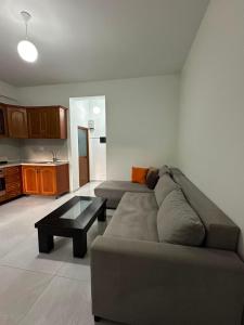 a living room with a couch and a coffee table at Ikon Apartments in Kashari