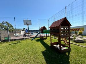 a park with a playground with a slide at Pokoje Gościnne Angelika in Swarzewo