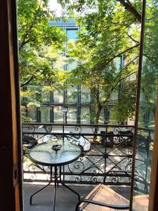 a view of a balcony with a table and chairs at Liberty Apartment And Rooms in Tbilisi City