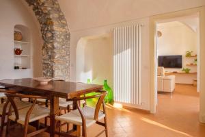 a dining room with a table and chairs at Villa Belvedere Amodeo - terrace, seaview, wifi in Conca dei Marini