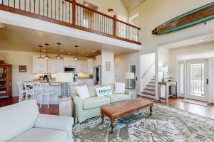 a living room with two couches and a table at Sweet Carolina in Edisto Island