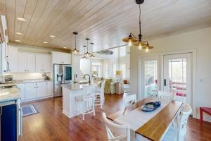 a kitchen and living room with a table and chairs at Sweet Carolina in Edisto Island