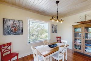 a dining room with a table and chairs and a window at Sweet Carolina in Edisto Island