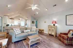 a living room with a couch and a table at Pompano End in Edisto Island