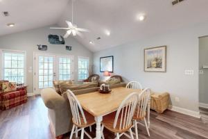 a living room with a table and a couch at Pompano End in Edisto Island
