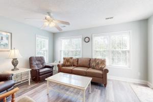 a living room with a couch and a table at Pompano End in Edisto Island +17 photos