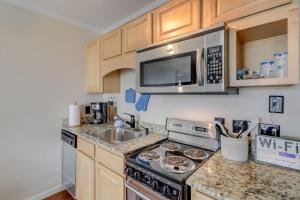 a kitchen with a stove and a sink and a microwave at HH Beach & Tennis 344B in Hilton Head Island +18 photos