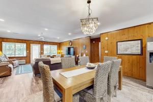 a dining room and living room with a table and chairs at Feeling Tip'Sea in Edisto Island