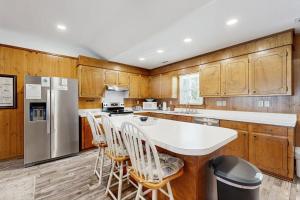 a kitchen with wooden cabinets and a white counter top at Feeling Tip'Sea in Edisto Island