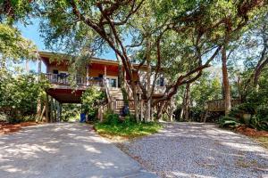 a house with a balcony on the side of a road at Natural Wonder in Edisto Island
